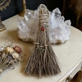 Detail of handmade witch broom with red gemstone and mystical metallic charms - Besom with Triple Moon and Red Agate / 20x13cm