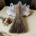 Detail of handcrafted witch broom with pink raw stone crystal and pentagram pendant decoration - Besom with Copper Pentagram and Strawberry Quartz / 20x13cm