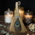 Detailed close-up of handmade witch broom with natural feather and crystal decoration - 20*10cm / Peacock Feather Triple Moon Citrine