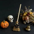 Detailed close-up of a mini witch broom with skull charm for Halloween home decoration - Black Witch