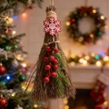 Close-up of a mini decorative witch broom with red berries, pine cones and felt snowflake - Snowflake Decor