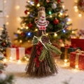 Detail of Christmas broom decor with Merry Christmas patch and pine needle accents - Santa Claus Decor
