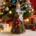 Detail of Christmas broom ornament with snowman, pine cone and berries in festive setting - Snowman Decor