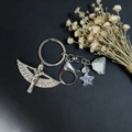 Silver metal keychain with Isis goddess pendant, colorful star bead, and natural crystal stone - Cross And Sodalite