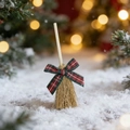 Close-up of decorative mini Christmas broom with plaid bow and wooden handle - Plaid Style 2