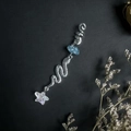 Detail of silver spiral dreadlock jewelry featuring blue raw stone and a star pendant - Blue Apatite With Snake And Star