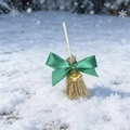 Detail of a Christmas decorative mini broom with green bow, gold bell, and snowy texture - Green Bell