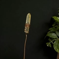 Macro detail of raw citrine crystal wrapped in copper wire for floral arrangement - Yellow