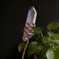 Detailed view of hand-wrapped natural amethyst crystal point with golden wire accents - AB Purple