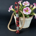 Detail of red and black paracord lanyard with Viking warrior and rune bead accents - Camo Red