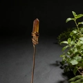 Macro detail of natural citrine crystal with artistic copper wire wrap on black background - Milk Tea