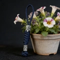 Detailed close-up of dark blue paracord keychain featuring silver viking mask and rune bead - Navy Blue
