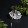 Macro detail of handmade copper wire wrapped around raw smoky crystal stone craft - Brown