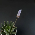 Detail of natural purple crystal stone hand-wrapped with gold wire on a decorative stick - Light Amethyst