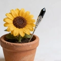 Close-up of a silver floral hair pin with a hexagonal black crystal stone in a pot - Black Stone