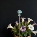 Detail view of light blue crystal mushroom garden stake with gold wire wrapping - Labradorite