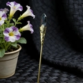 Detailed view of vintage gold hair pin featuring dark hexagonal crystal and floral metalwork - Mahogany Obsidian