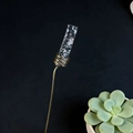 Detail of crystal floral pick with gold wire wrap and marble stone accent on long stem - Rhodonite
