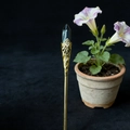 Detail of vintage gold hairpin with black hexagonal crystal and ornate hollow carving - Ironstone
