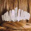 Detailed view of raw clear quartz crystals on a silver comb styled in braided brown hair - Crown Style Clear (06)