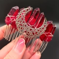 Macro shot of red raw crystal hair comb with silver hollow moon detail and wire wrap - Deep Red Moon