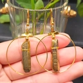 Detailed close-up of Bohemian gold hoop earrings featuring raw natural crystal clusters - Gold & Gold Hoop