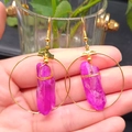 Detail of bohemian gold hoop earrings with purple crystal pendant and wire wrap - Rose Red & Gold Hoop