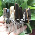 Detail of handmade tiger eye stone hair comb with silver crescent moon held in hand - Tiger's Eye