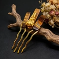 Detail view of handmade tiger eye stone hair comb with golden animal skull and dry flowers - Tiger Eye + Gold Comb Gold Crow Head