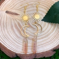 Detail of sun and moon crystal earrings featuring orange hexagonal quartz and golden wire - Champagne Crystal
