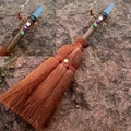 Macro shot of handcrafted wicca witch broom with colorful crystals and blue stone tip - Plated Grey Blue Crystal With Mixed Gemstone Beads