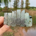 Detailed close-up of triple moon hair clip with natural green quartz crystals - Prehnite & Triple Moon