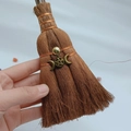 Detailed macro of a handmade mini wicca witch broom with copper wire and pentagram charm - Pentagram Moon Style (07)