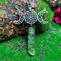 Macro detail of Triple Moon Goddess necklace with raw green crystal on mossy bark - Natural / Triple Moon Cracked Green Crystal Necklace
