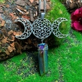 Detailed close-up of handmade Triple Moon necklace with aura crystal on natural tree bark - Natural / Triple Moon Multicolored Crystal Necklace