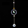 Close-up of a golden crystal suncatcher featuring a blue lapis lazuli ring and moon pendant - Lapis Lazuli