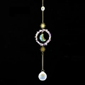 Detail of suncatcher with natural amethyst stones, crystal ball, and gold moon moon charms - Fluorite