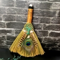 Detail of crystal witch broom with peacock feathers and bronze tree of life charm - Rose Quartz Tree of Life with Top Crystal