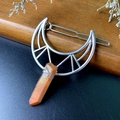 Macro shot of a moon-shaped hair clip with orange crystal and silver wire wrapping - Hollow Barrette / Brown