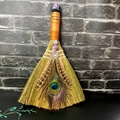 Macro shot of altar broom featuring peacock feathers and raw amethyst crystal detail - Star