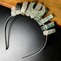 Close-up of handmade natural crystal headband featuring a metal moon and wire wrapping - Black Rutilated Quartz Hollow Moon Style