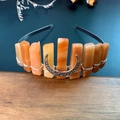 Detail of handmade orange crystal crown with silver moon on rustic wooden table - Red Aventurine + Moon