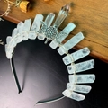 Detailed close-up of natural white crystal quartz crown with moon goddess metal symbol - Clear Quartz + Triple Moon Crown
