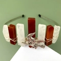 Detail of gothic crown featuring raw crystals and silver witch pendant on green background - Red Agate + White Crystal + Witch