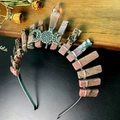Macro detail of natural pink quartz crown with wire-wrapped Triple Moon Goddess symbol - Rhodochrosite + Triple Moon Crown