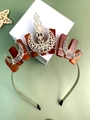 Macro detail of Bohemian crown featuring raw red crystals, silver moon, and central pearl - Red Agate