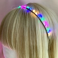 Macro view of multi-color LED glowing beads on silver wire headband for hair decoration - Rainbow