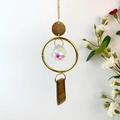 Detail of hanging crystal wind chime with gold chain, faceted ball and tiger eye stone - Tiger's Eye