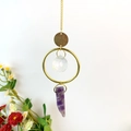 Detail of crystal suncatcher with gold rings and natural purple amethyst stone pendant - Amethyst
