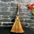 Close-up of handmade brown witch broom with crystal moon and skull metal charms - Orange Red Stone Moon Pentagram Style (09)